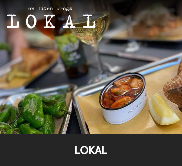 Smårätter och vin på bord i restaurangmiljö hos LOKAL